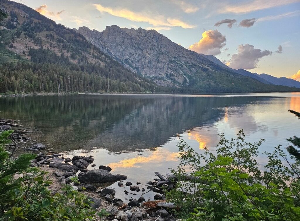 photo of lake in foreground and mountain in background
