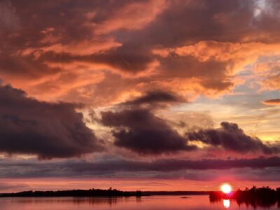 photo of sunset over body of water, with pinks and purples at horizon