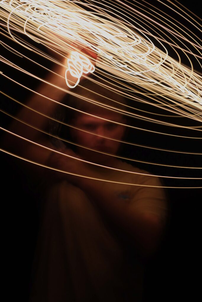 Image of spiraling light held by boy in background