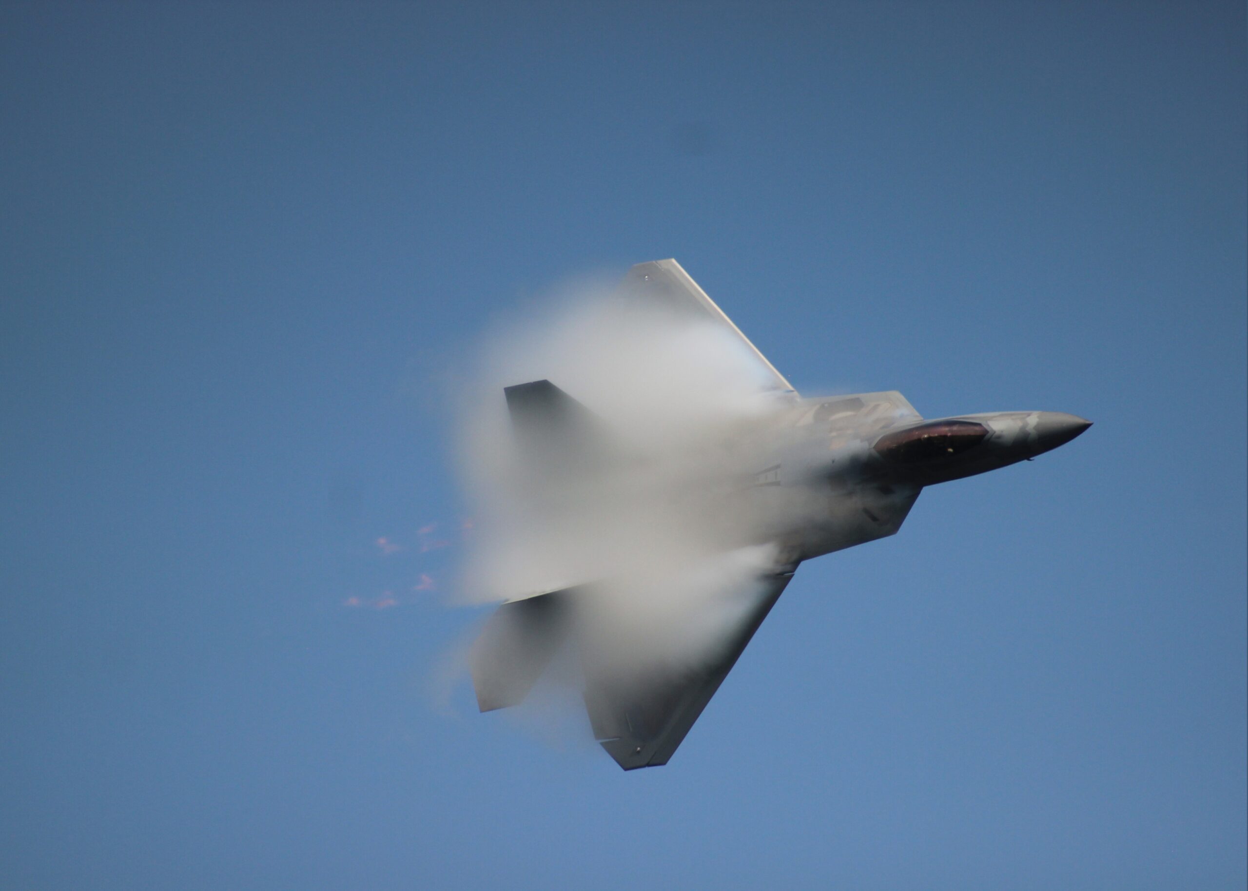Jet zooming through blue sky