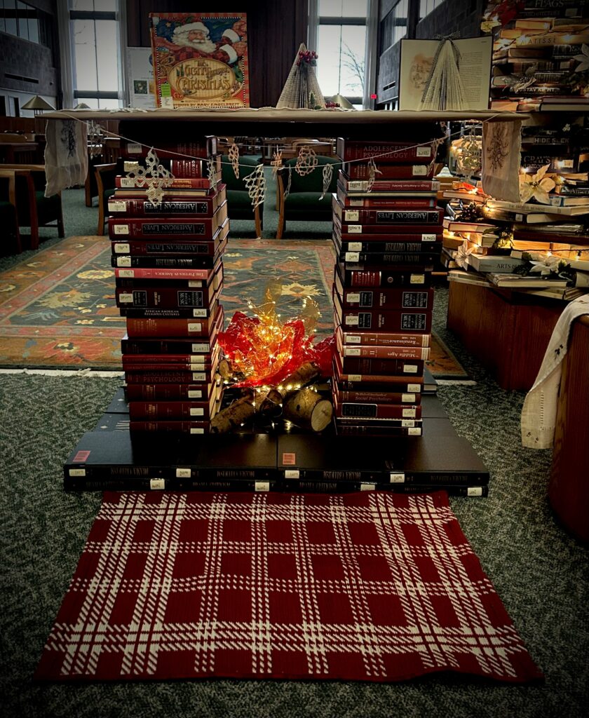 fireplace made of books with snowflake garland and twinkly tissue paper
