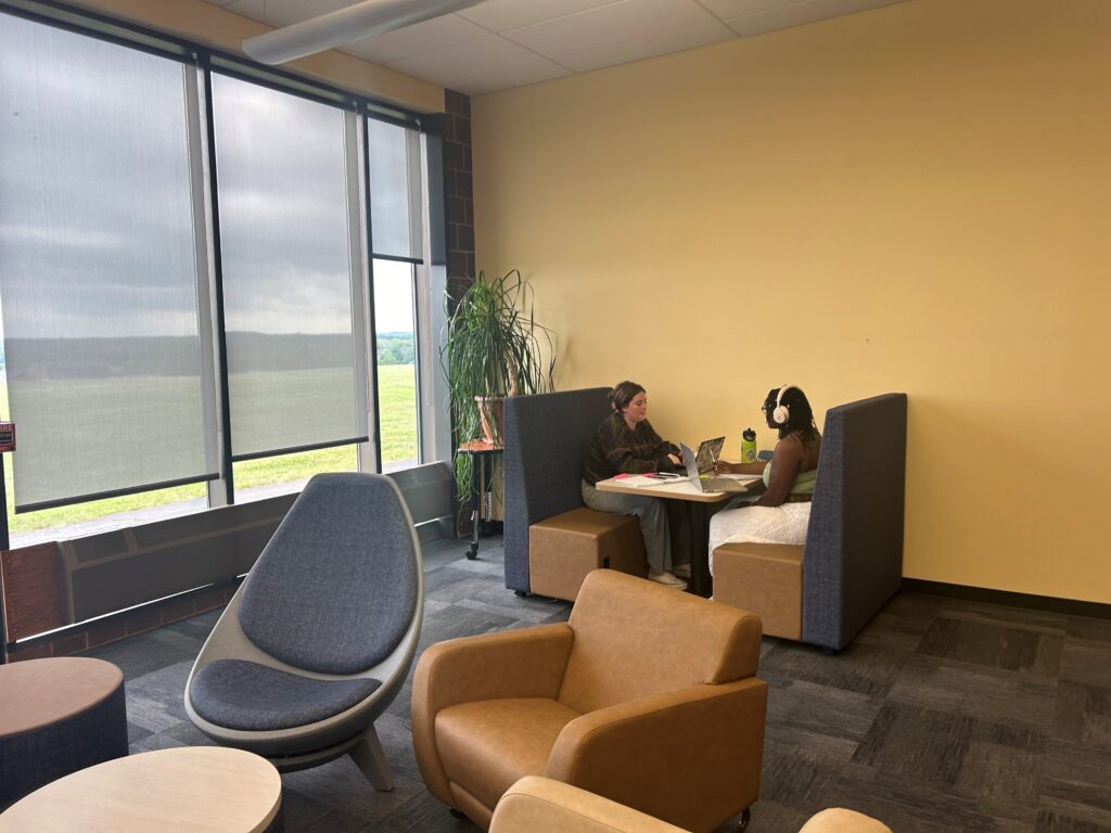 Two students studying at new booth in our lounge area